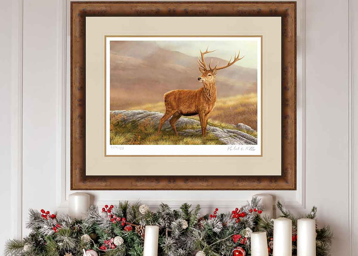 Framed painting of a deer in a natural setting above a festive fireplace.
