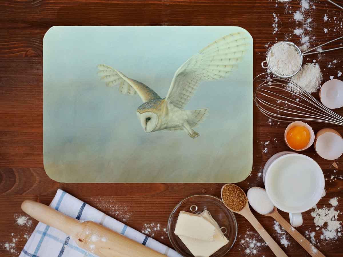 glass chopping board work top saver featuring barn owl with wooden spoon and cooking ingredients