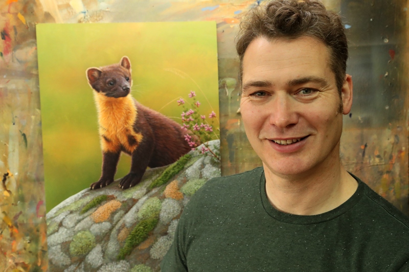 Robert E Fuller with his painting of a pine marten