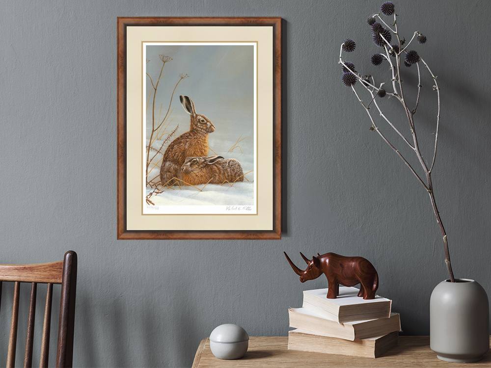 painting featuring hare framed on wall surrounded by top of chair, desk and vase of dried flowers