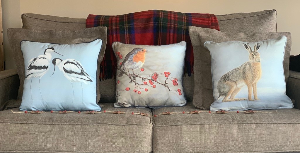wildlife art theme cushions on sofa